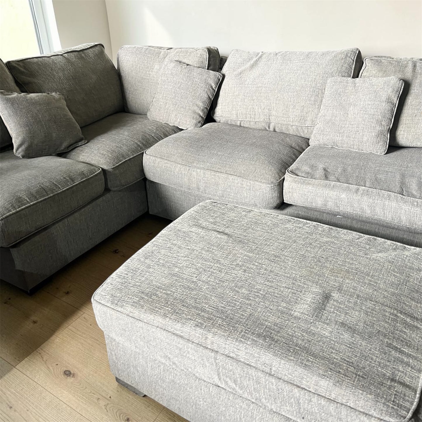 Grey corner sofa with matching footstool
