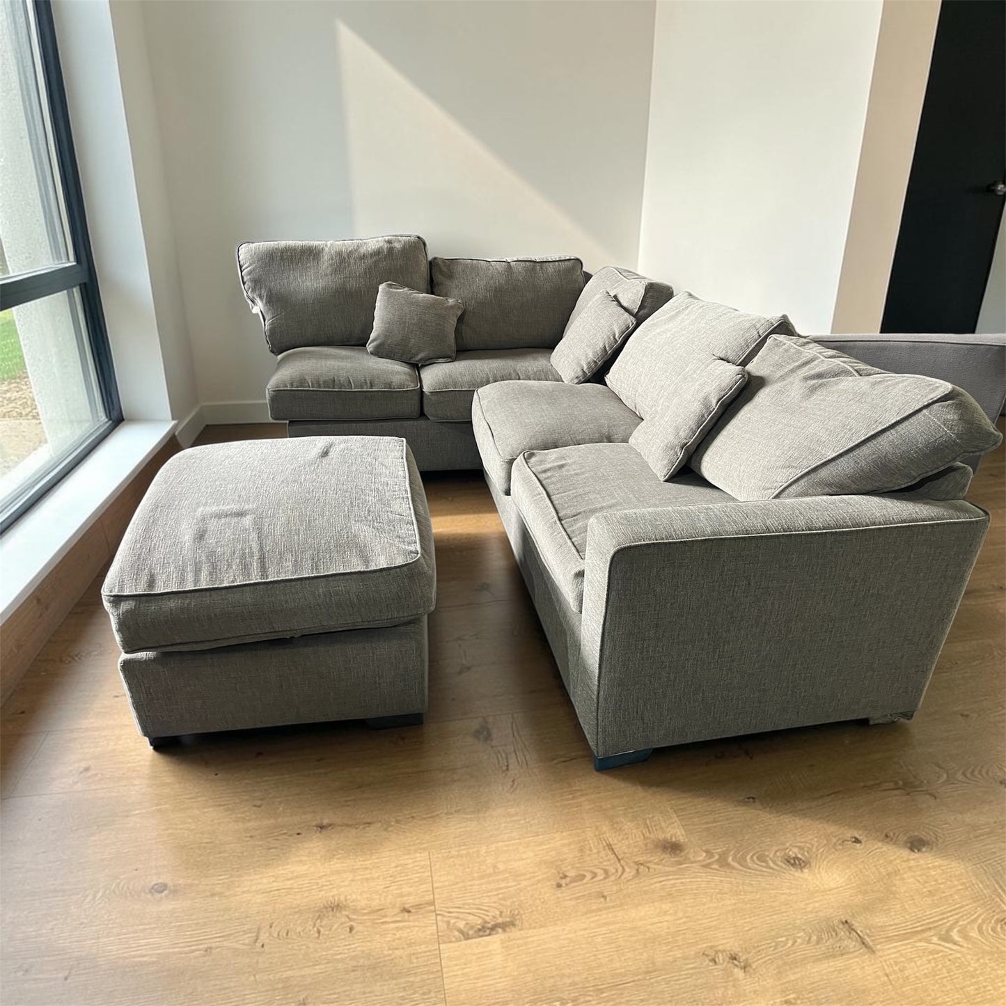 Grey corner sofa with matching footstool